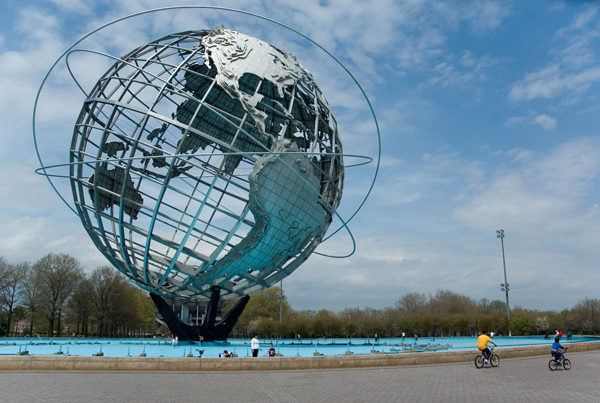The Unisphere, a world globe with open spaces, stands
against a blue sky.