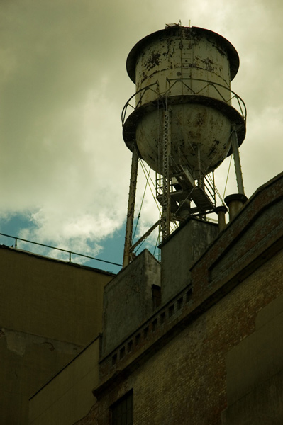 A metal water tank with ladders and balconies stands out
against the sky.