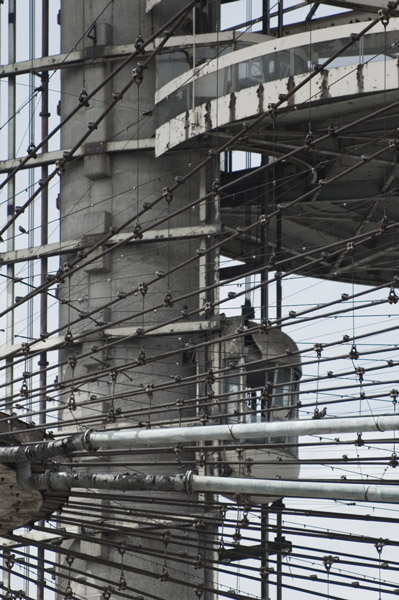 A network of cabling supports a steel tower.