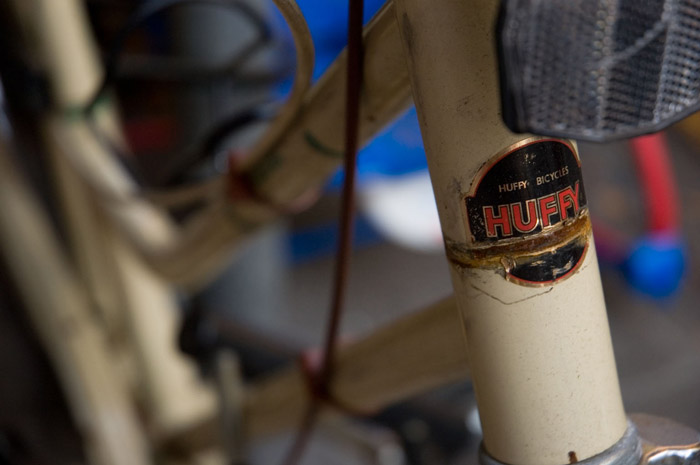 A bicycle's head badge, below a reflector, reads 'Huffy.'