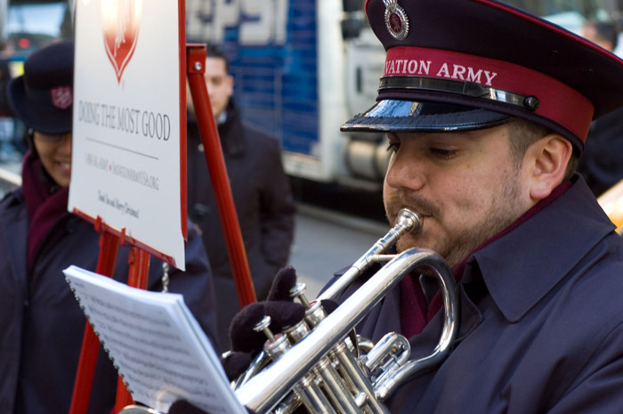 A Salvation Army trumpeter plays for donations.