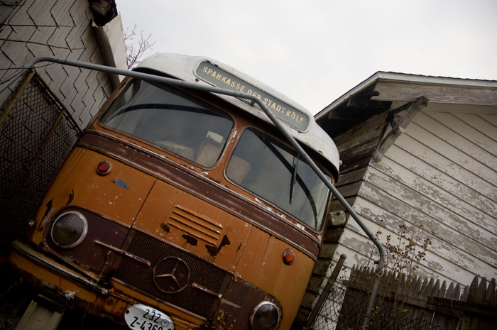 A bus from Germany is wedged between two residential buildings in Queens.