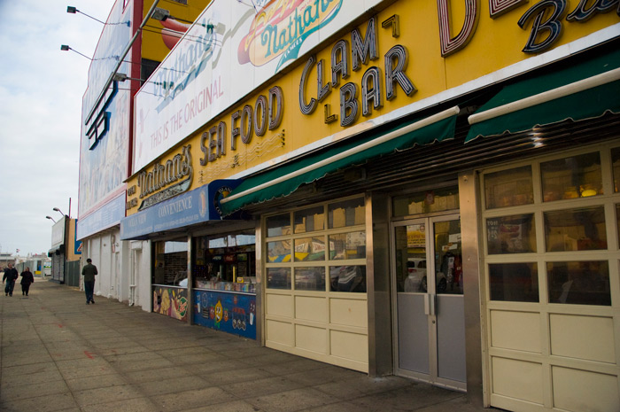 Nathan's of Coney Island, with signs about their hot dogs, seafood, and clam bar.