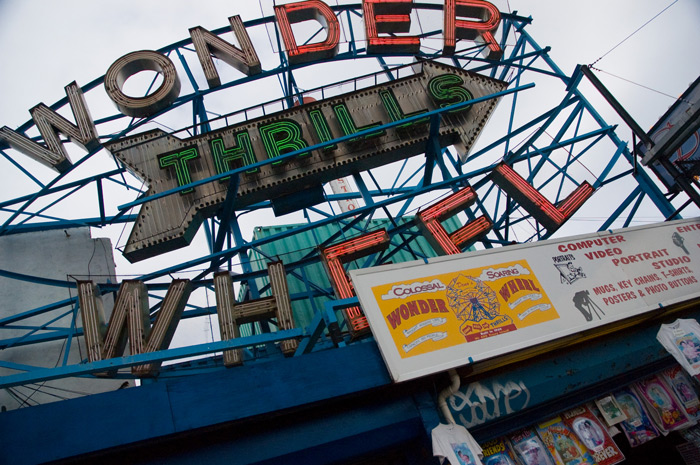 A live neon sign, partially lit, advertises Coney Island's famous Wonder Wheel ride.