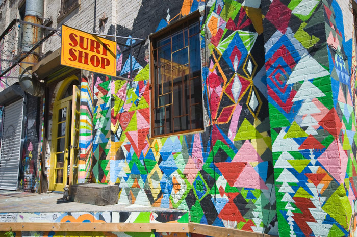 A store's outer walls have been painted with a wide assortment of colorful geometric figures.