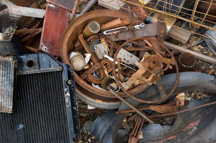 A pile of rusting cans and auto parts.