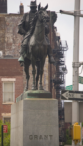 A statue of Ulysses Grant on horseback, dressed for war, on top of a pedestal.
