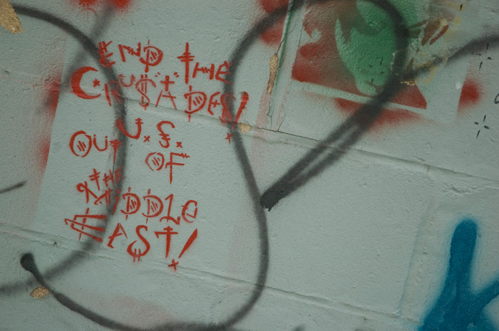 Stenciled graffiti calls for the United States to exit the Middle East.