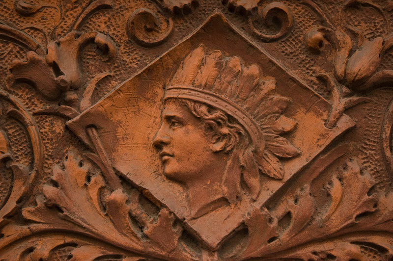 A terra cotta Indian Head, with feathered head dress, ornaments a residence.
