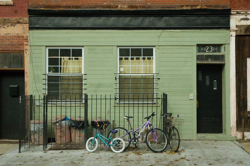 A small home with three bicycles parked outside