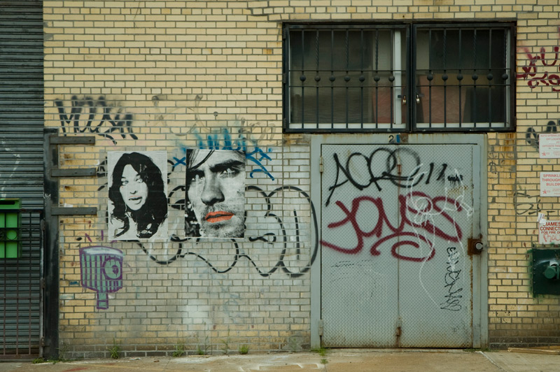 A graffiti tag, 'Jones,' amidst other tags and posters.
