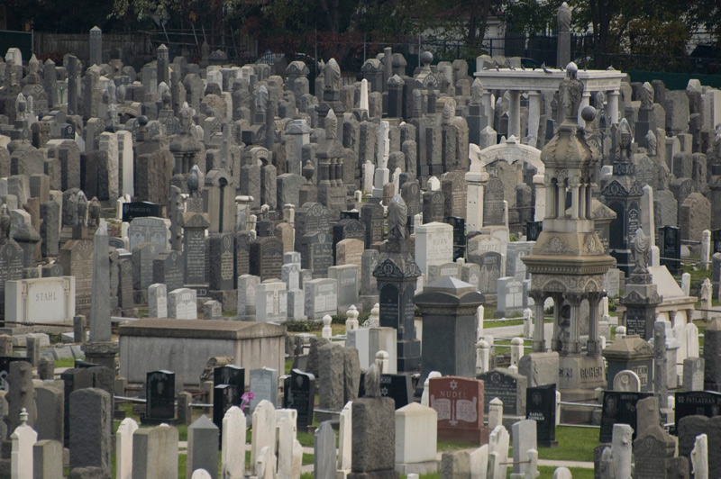 A densely packed cemetery, with varied tombstones.