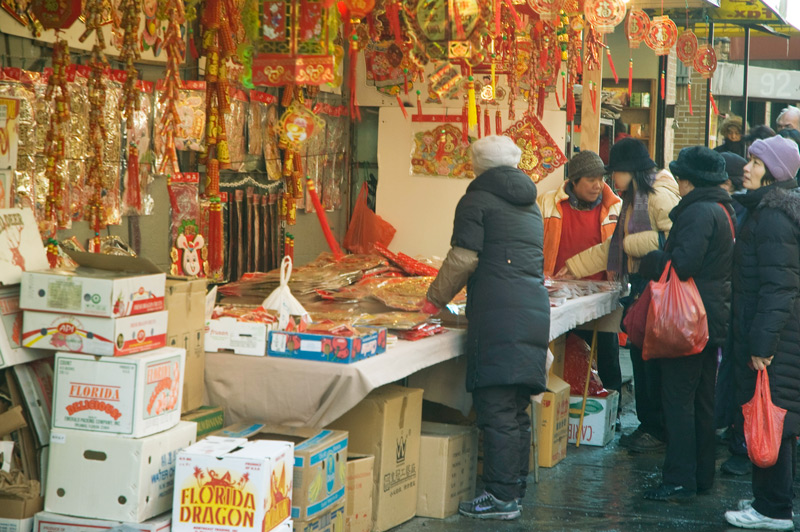 Asian-Americans scan New Year decorations at a store.