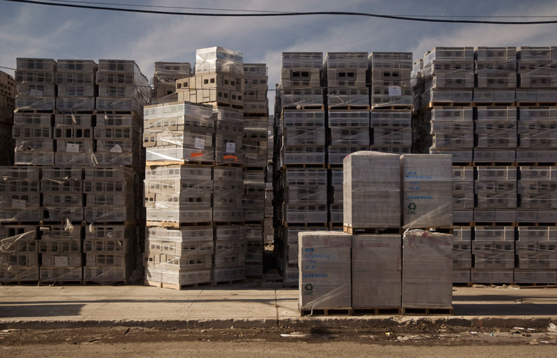 A multitude of masonry blocks, on pallets and wrapped in plastic.