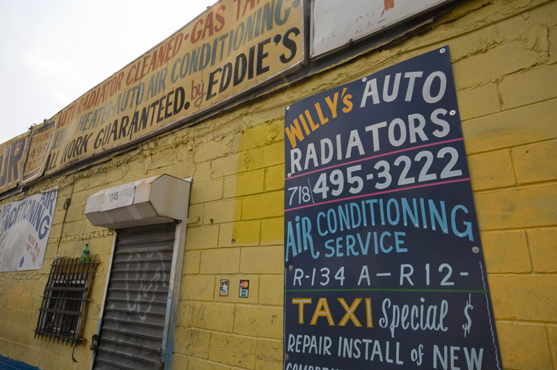 Hand-painted signs adorn an auto repair shop.