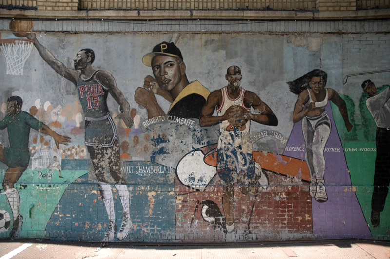 A mural celebrating black athletes such as Pele, Wilt Chanberlain, and Roberto Clemente.