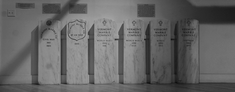A display of white marble 'military' tombstones.