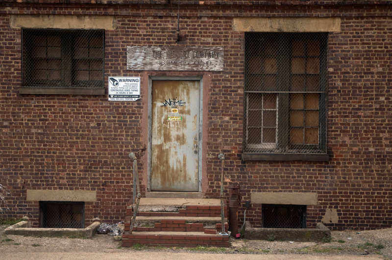 A side door on a brick industrial building.