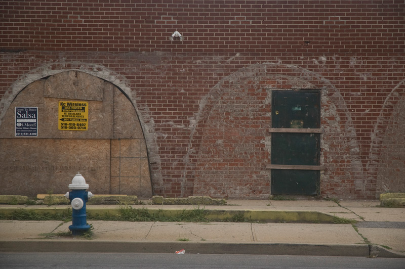 Arched windows, covered in brick.