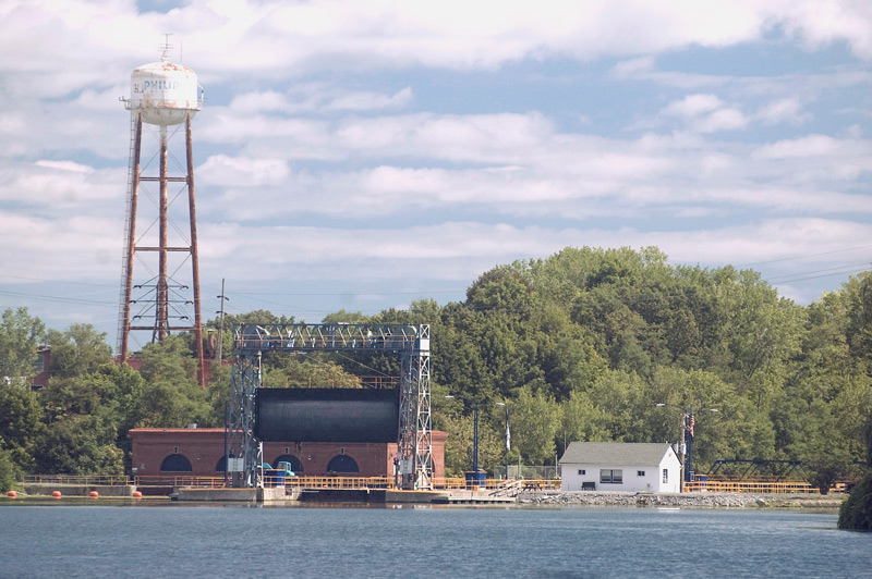A water tower and a blue lake.