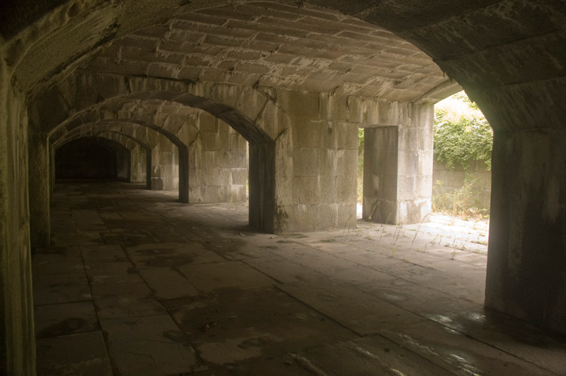 Light breaks through a series of stone arches.