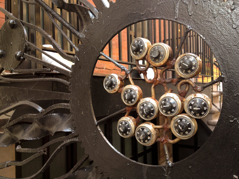 Many combination locks in a circle of cast iron work.