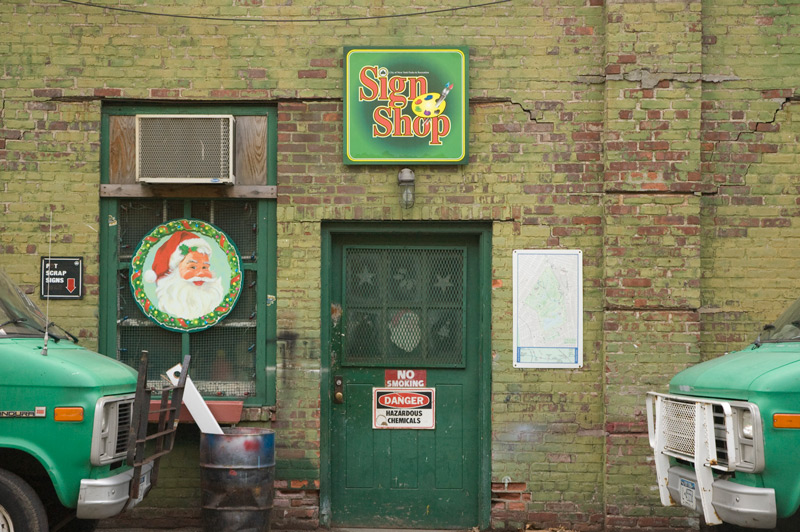Cheerful signs on a green brick building