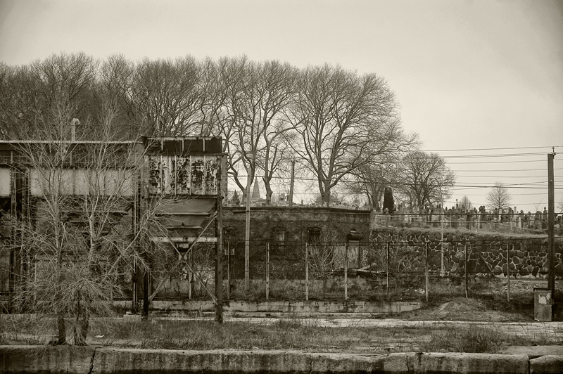 Bare trees and an industrial structure.