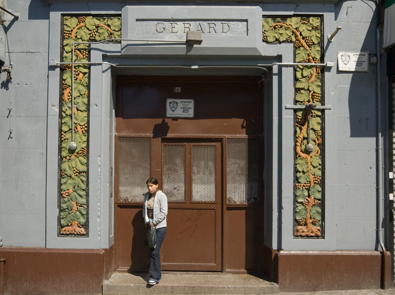 A woman at the entrance to an apartment building