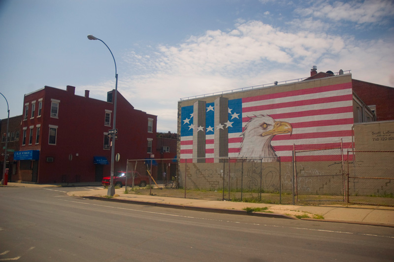 A mural of the twin towers and an eagle against an American flag.