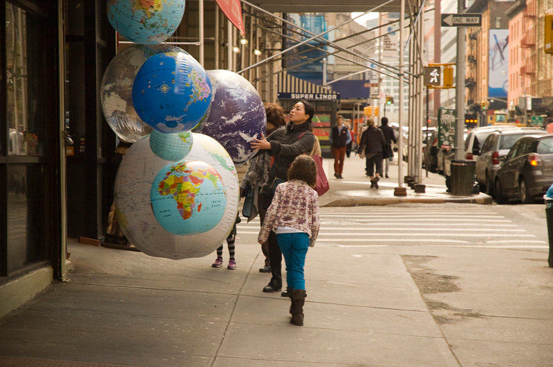 A family examines inflated globes.