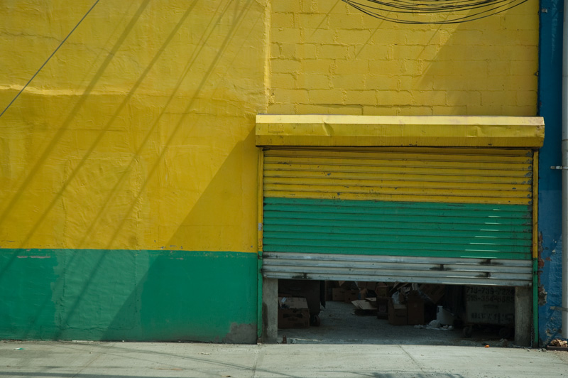 Green and yellow colors on a wall, out of alignment.