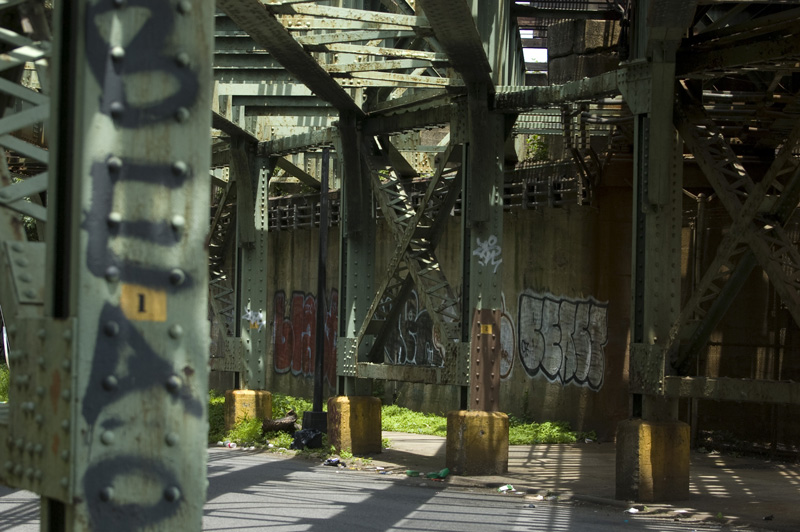 Metal pillars under train tracks.