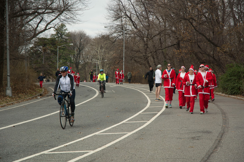 Several people in Santa Claus outfits on Prospect Park's loop.
