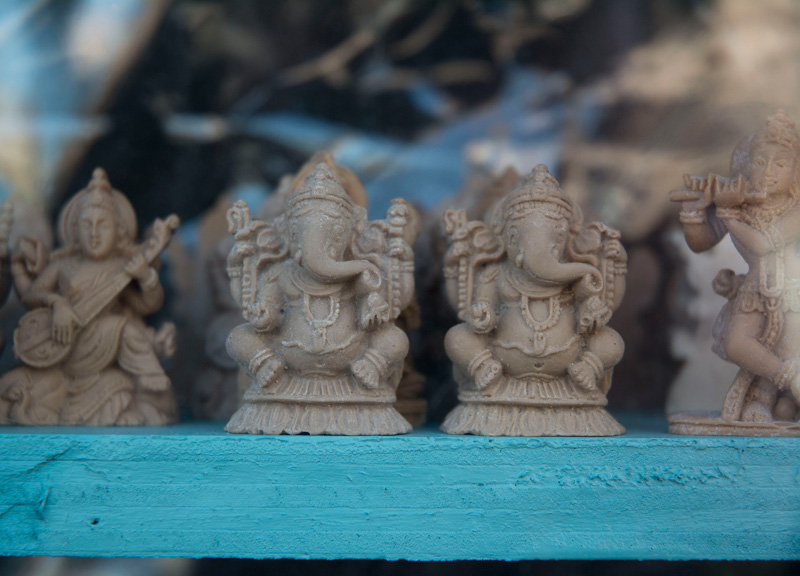 Figurines of Ganesh on a shelf.