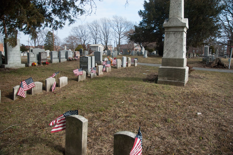 A set of military graves, with flags.