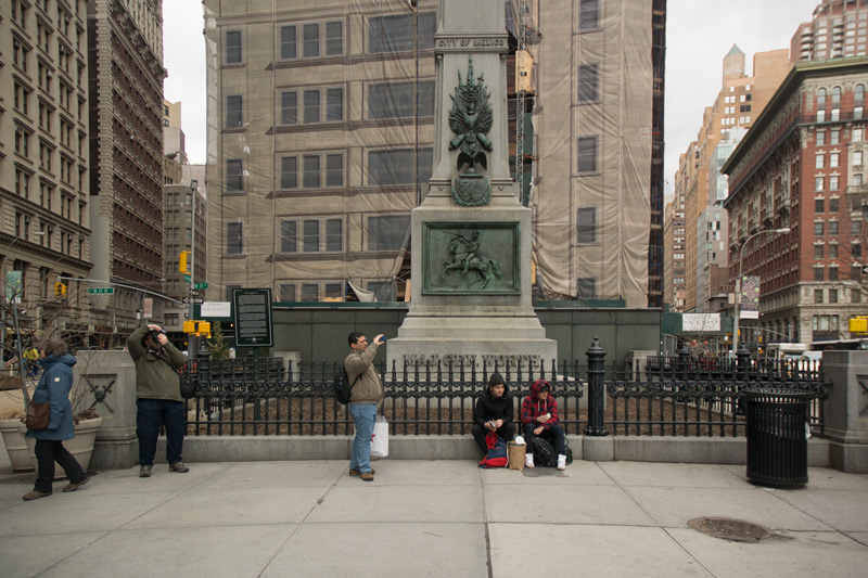 Tourists taking pictures at Worth Plaza, by the Flatiron Building.