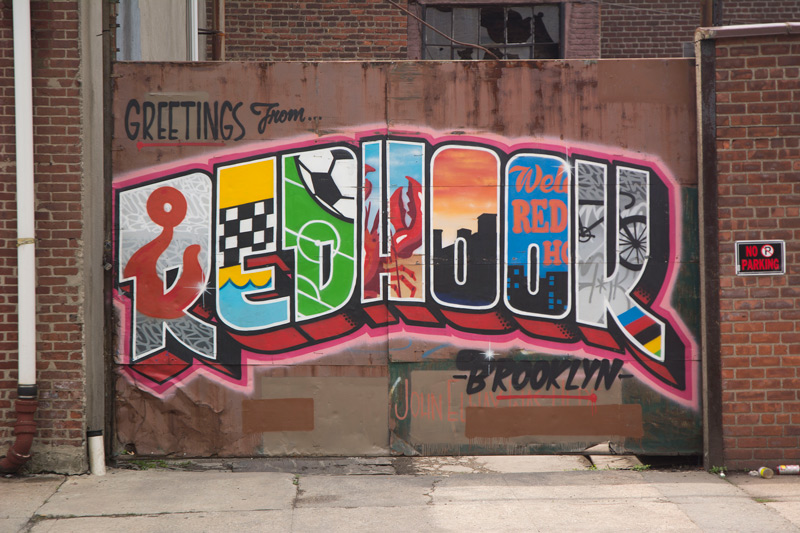 A mural, painted like a toursim post card, featuring aspects of Red Hook