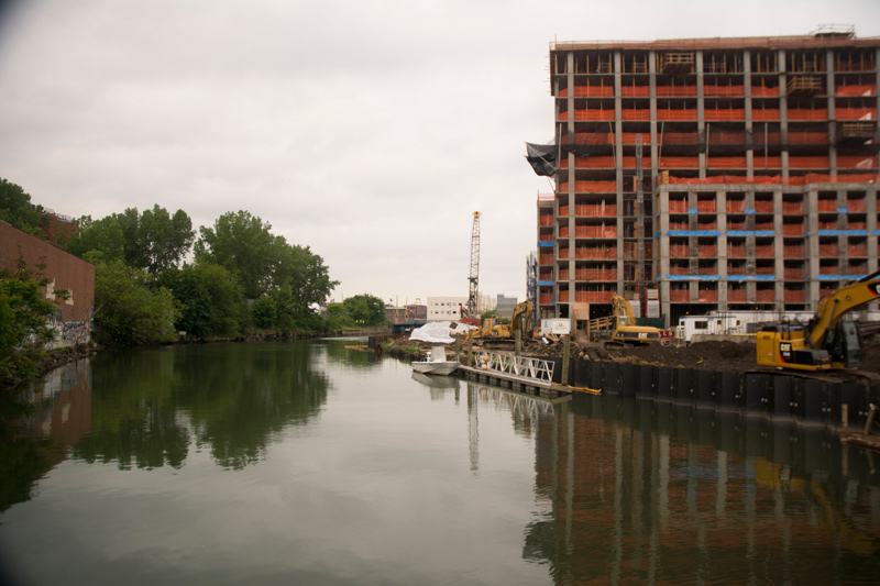 A high rise apartment building in construction, alongside the toxic Gowanus Canal.