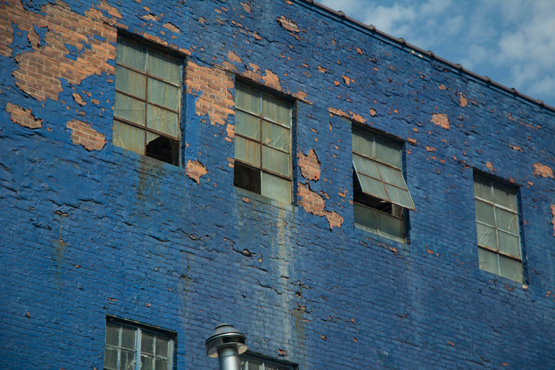 An old brick building, painted blue.