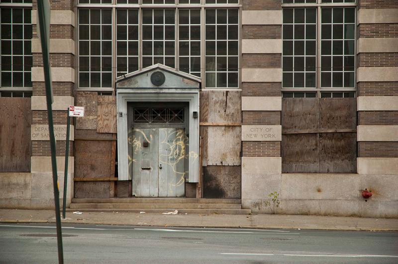 A regal entrance to a city building, fallen into decay.