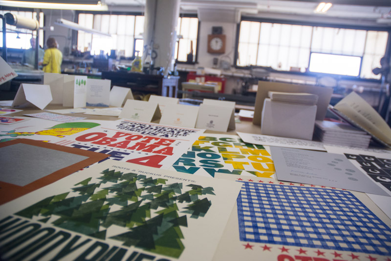 Artistic posters and cards on the table of a print shop.