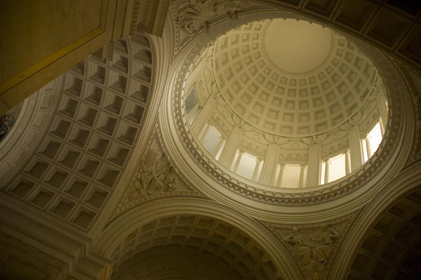 A dome has square of light and darkness.