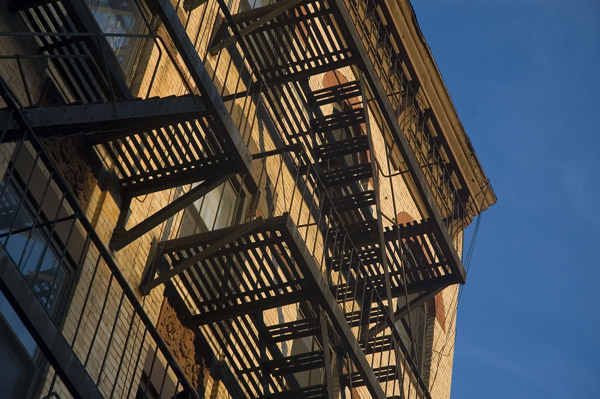 A beige building with a fire escape in contrast to a deep
blue sky.